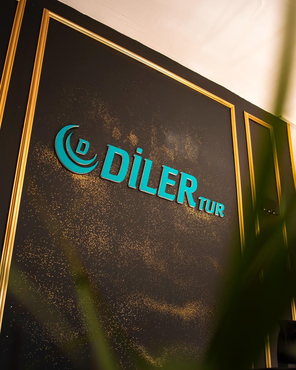 Diler Tur ofisinde duvardaki turkuaz Diler Tur logosu